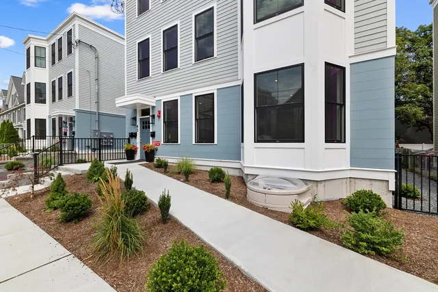 a front view of a house with a garden