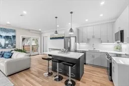 a kitchen with kitchen island a large counter top space appliances and a center island