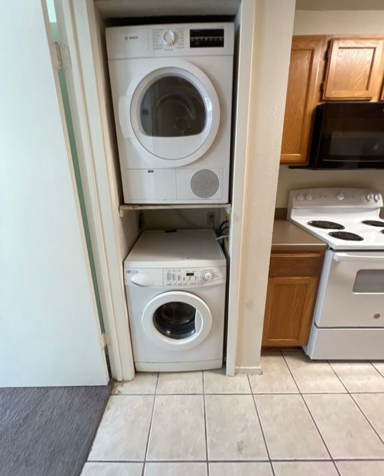 3115 Helms Street, Unit 111 Austin, TX 78705 - Photo 4 of 13 A compact laundry area includes stacked appliances for efficient use of space.
