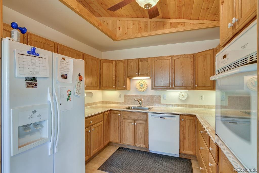 681 Forge Road Hartsel, CO 80449 - Photo 11 of 41 a kitchen with a sink a refrigerator a stove and cabinets