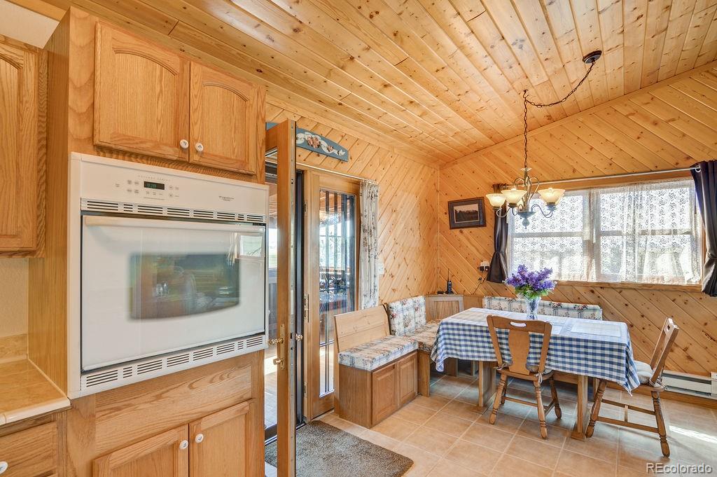 681 Forge Road Hartsel, CO 80449 - Photo 12 of 41 a dining room with furniture and a window