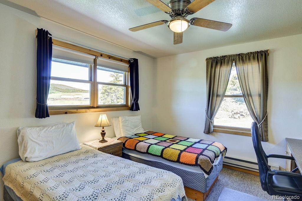 681 Forge Road Hartsel, CO 80449 - Photo 19 of 41 a bedroom with a bed and a window