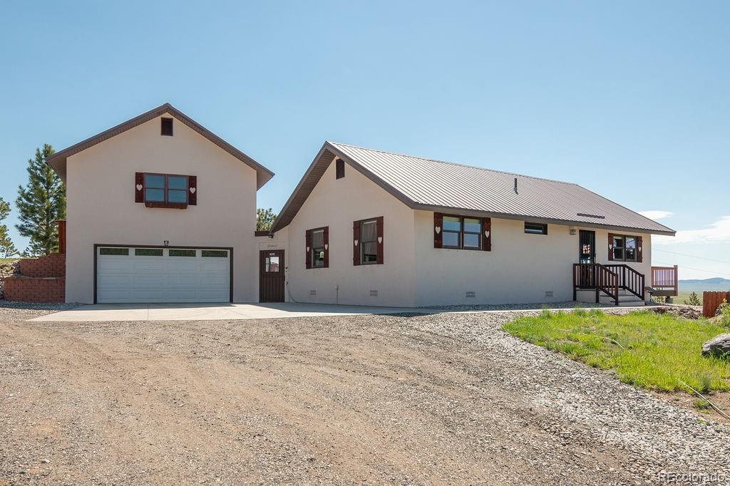681 Forge Road Hartsel, CO 80449 - Photo 2 of 41 a front view of house with yard and garage