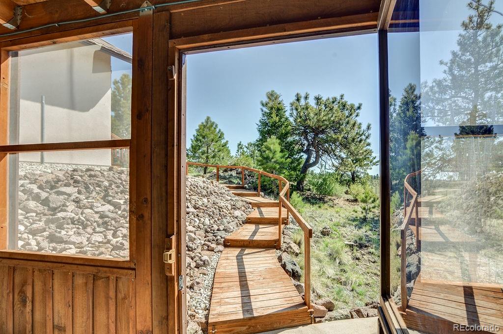 681 Forge Road Hartsel, CO 80449 - Photo 22 of 41 a front view of a house with a glass door