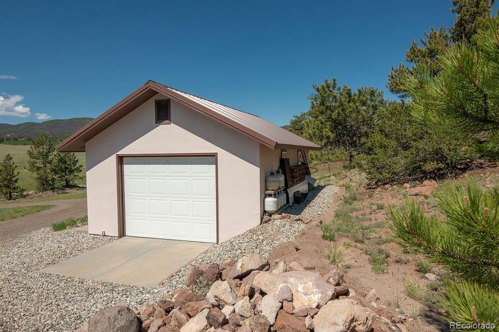 681 Forge Road Hartsel, CO 80449 - Photo 34 of 41 a front view of house with yard and trees in the background