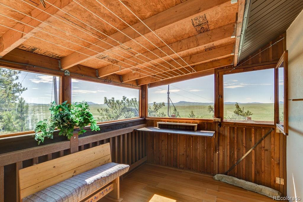 681 Forge Road Hartsel, CO 80449 - Photo 6 of 41 a view of deck with mountain view and wooden floor