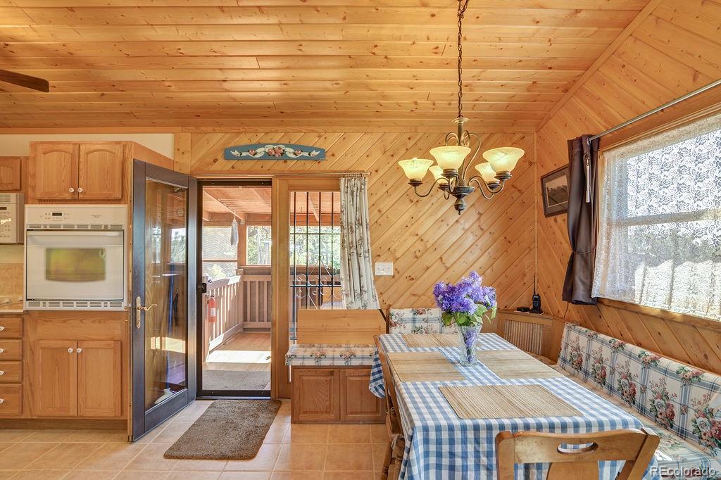 681 Forge Road Hartsel, CO 80449 - Photo 8 of 41 a view of a dining room with furniture wooden floor and a chandelier