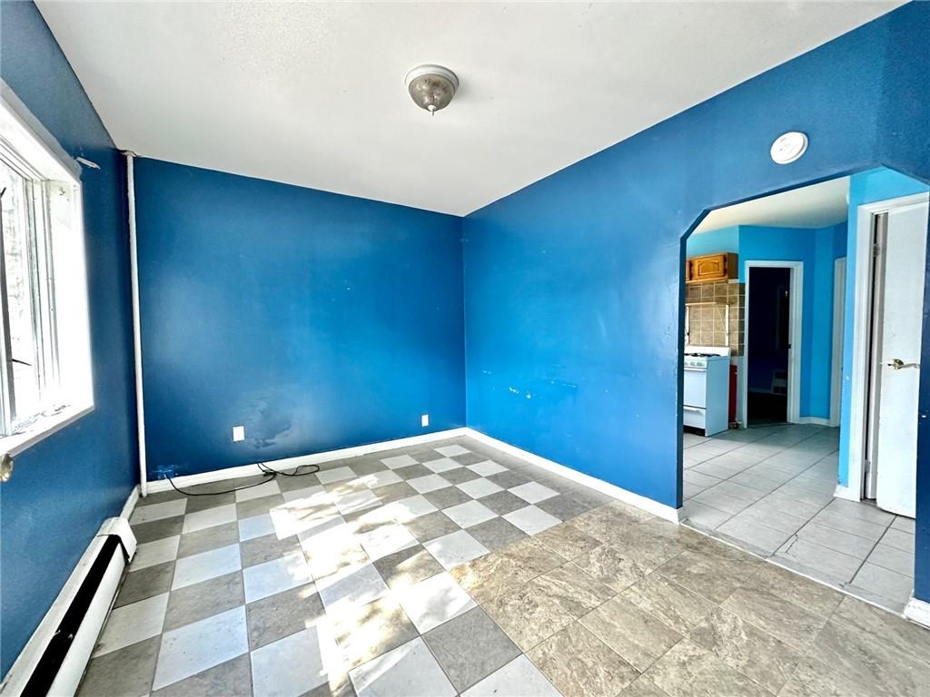 457 Van Sicklen Street Brooklyn, NY 11223 - Photo 6 of 8 a view of a livingroom with a ceiling fan and window