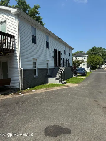 a view of a house with a yard and garage