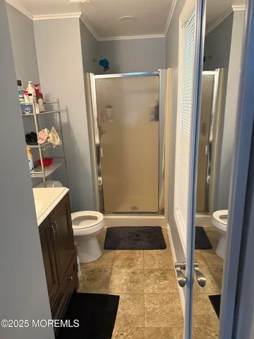 a bathroom with a toilet and a shower