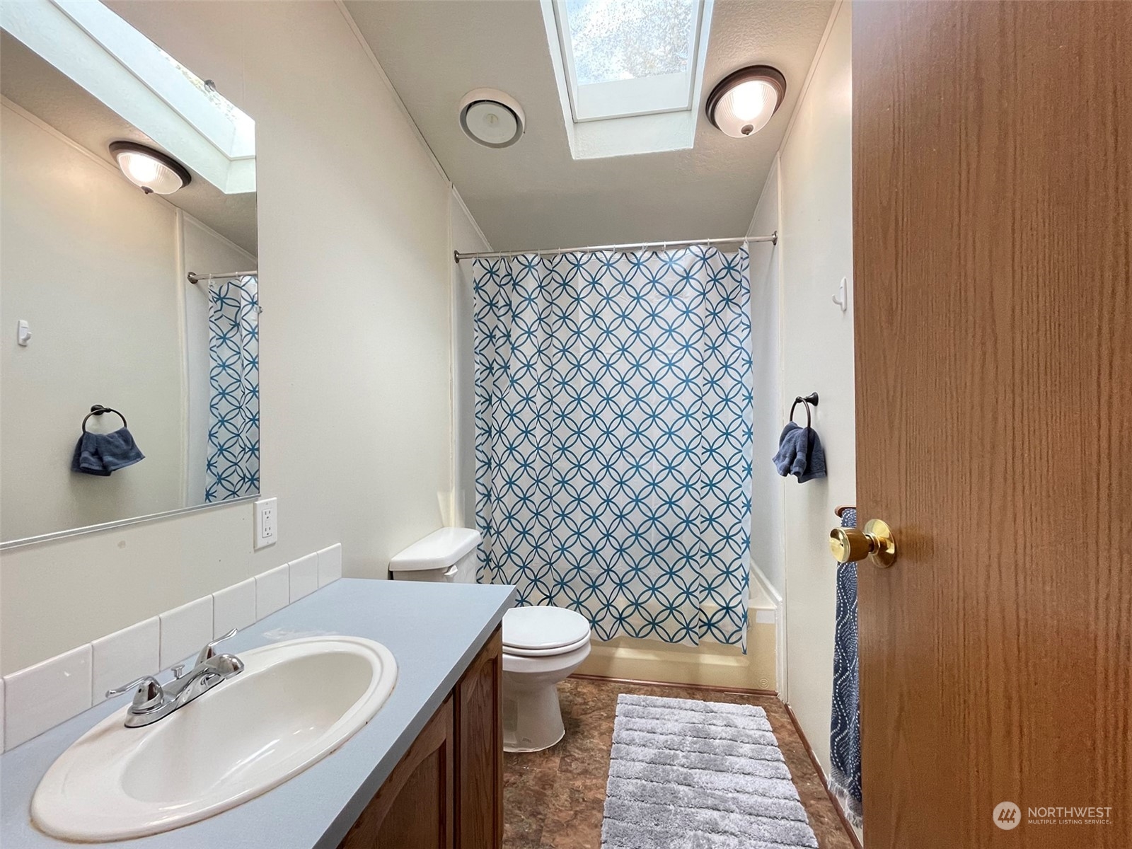 1010 Lemmon Road Port Angeles, WA 98362 - Photo 21 of 40 a bathroom with a sink a toilet a shower and a mirror