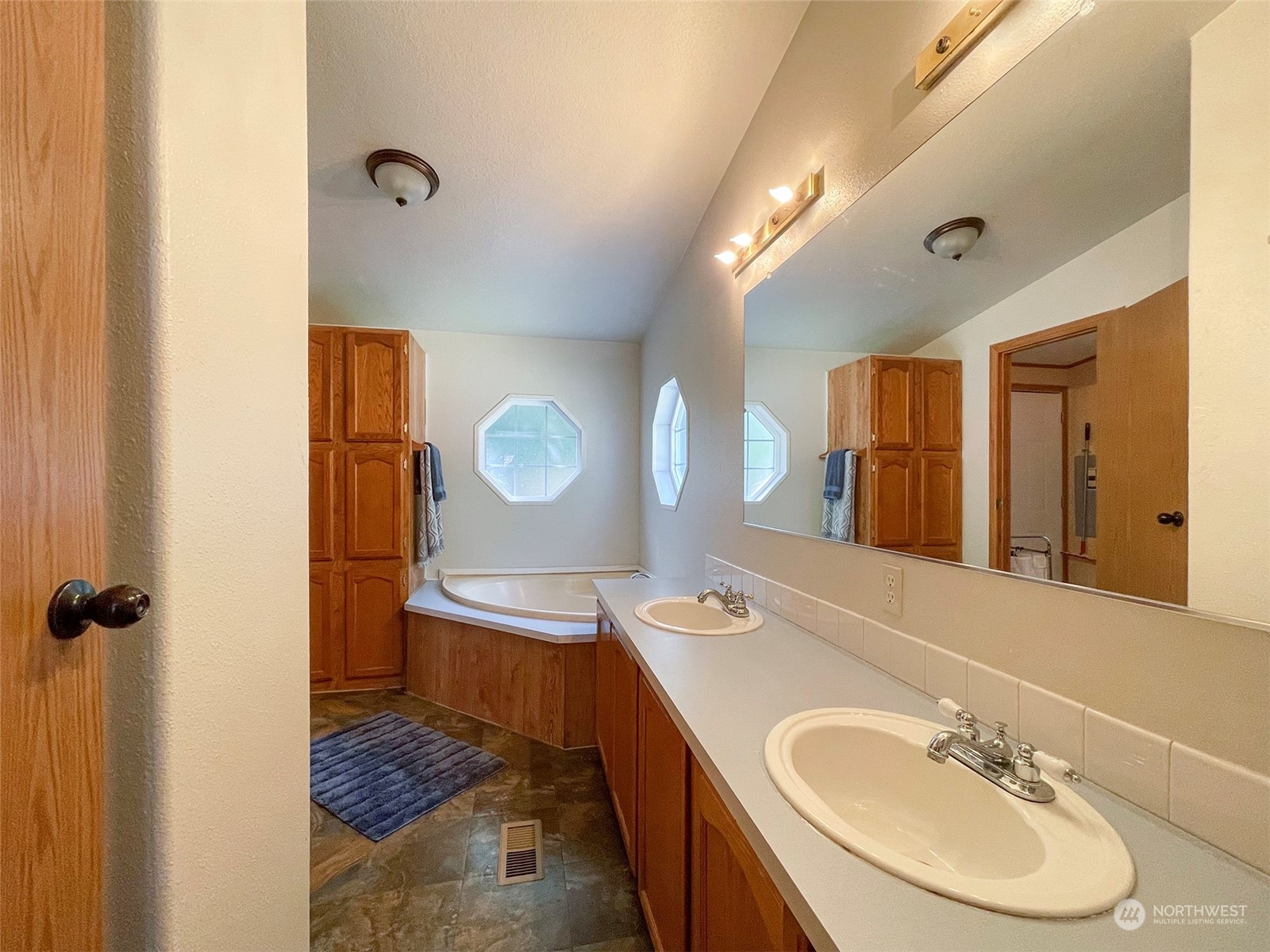 1010 Lemmon Road Port Angeles, WA 98362 - Photo 31 of 40 a bathroom with a sink double vanity and a mirror