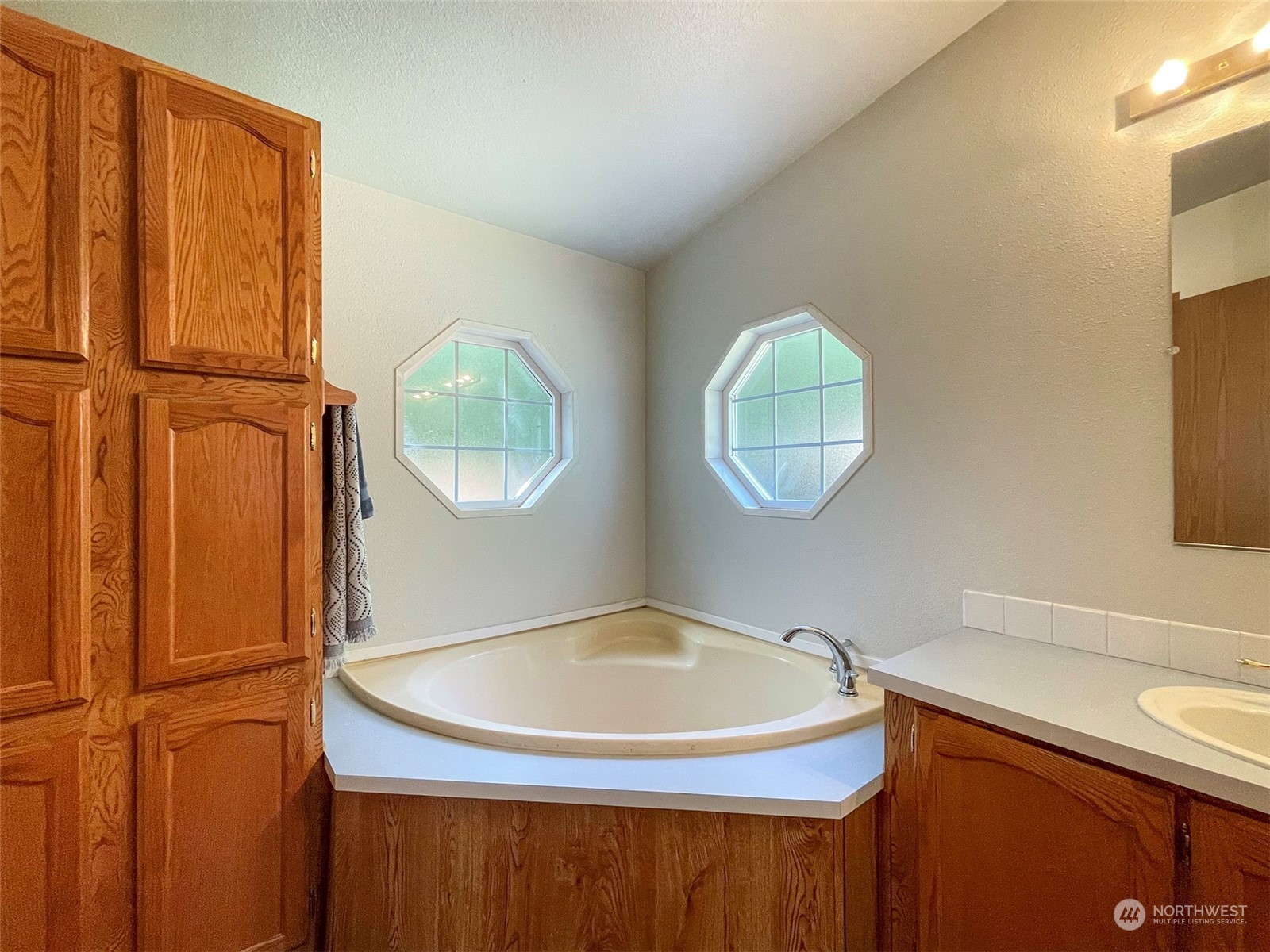 1010 Lemmon Road Port Angeles, WA 98362 - Photo 32 of 40 a bathroom with a sink and a mirror