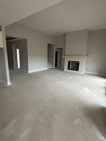 a view of an empty room with a fireplace