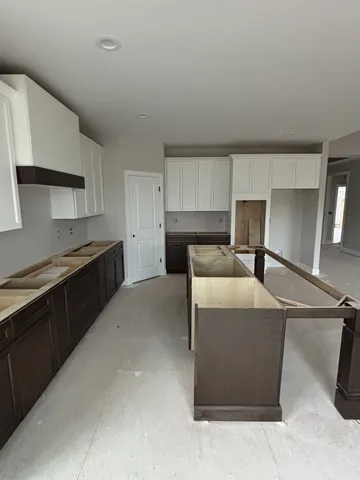 a kitchen with a cabinets and a stove top oven