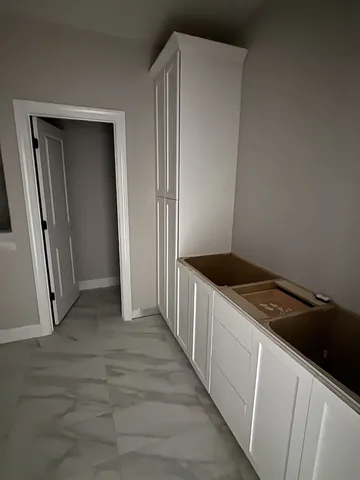 a kitchen with a refrigerator and a stove