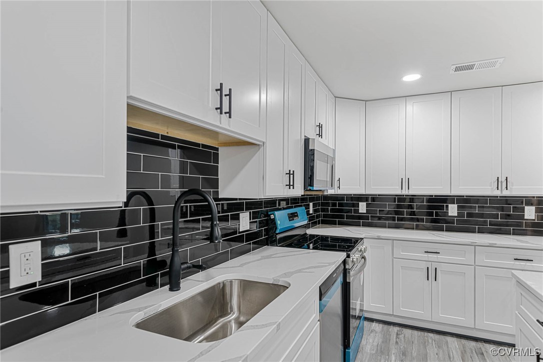 15412 Moores Mill Road Ruther Glen, VA 22546 - Photo 10 of 31 a kitchen with granite countertop a sink a stove and cabinets