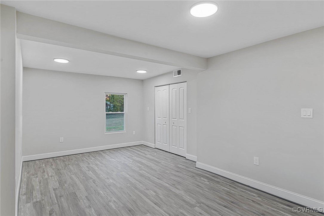 15412 Moores Mill Road Ruther Glen, VA 22546 - Photo 13 of 31 a view of an empty room with wooden floor and a window