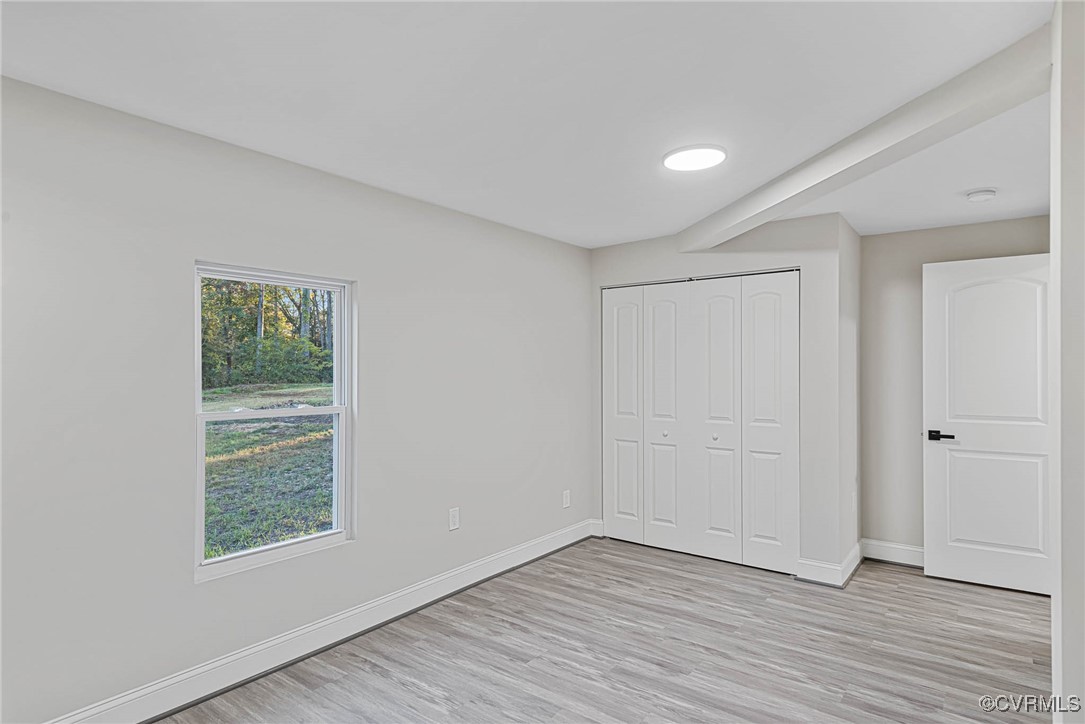 15412 Moores Mill Road Ruther Glen, VA 22546 - Photo 16 of 31 a view of an empty room with wooden floor and a window