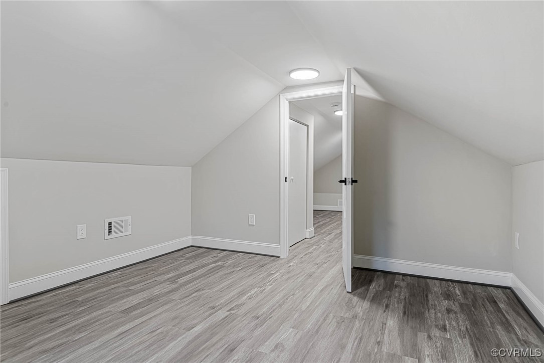 15412 Moores Mill Road Ruther Glen, VA 22546 - Photo 26 of 31 an empty room with wooden floor and white walls