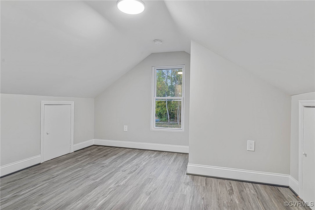 15412 Moores Mill Road Ruther Glen, VA 22546 - Photo 27 of 31 an empty room with wooden floor and windows