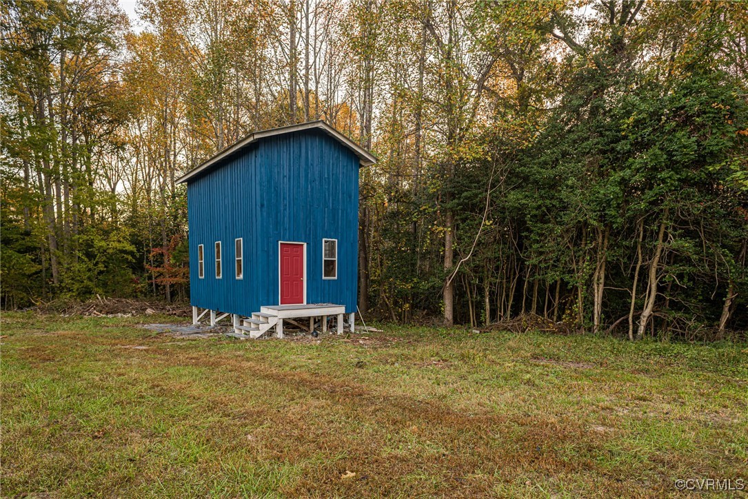15412 Moores Mill Road Ruther Glen, VA 22546 - Photo 30 of 31 a house is sitting in middle of forest