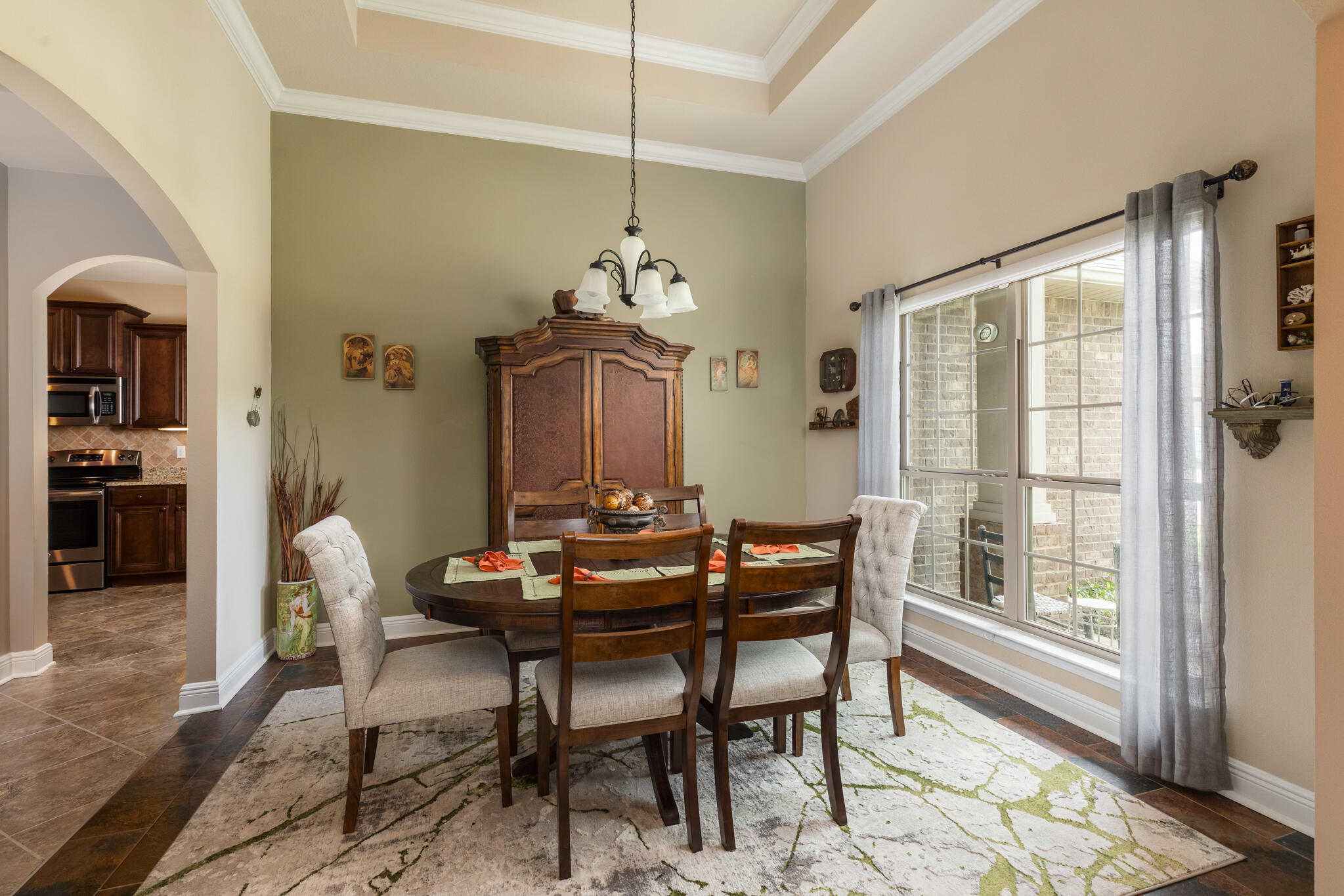 3379 Citrine Circle Crestview, FL 32539 - Photo 13 of 33 a dining room with furniture a chandelier and wooden floor