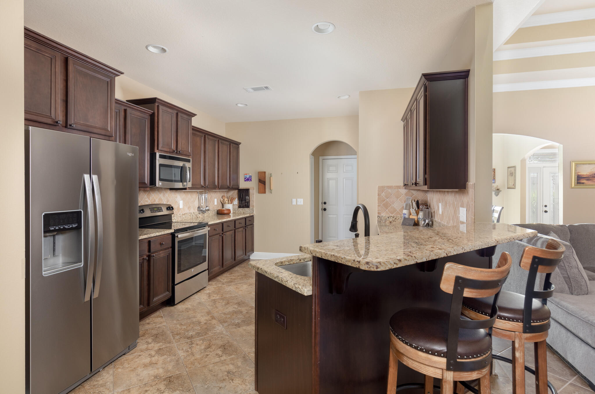3379 Citrine Circle Crestview, FL 32539 - Photo 14 of 33 a kitchen with refrigerator cabinets dining table and chairs