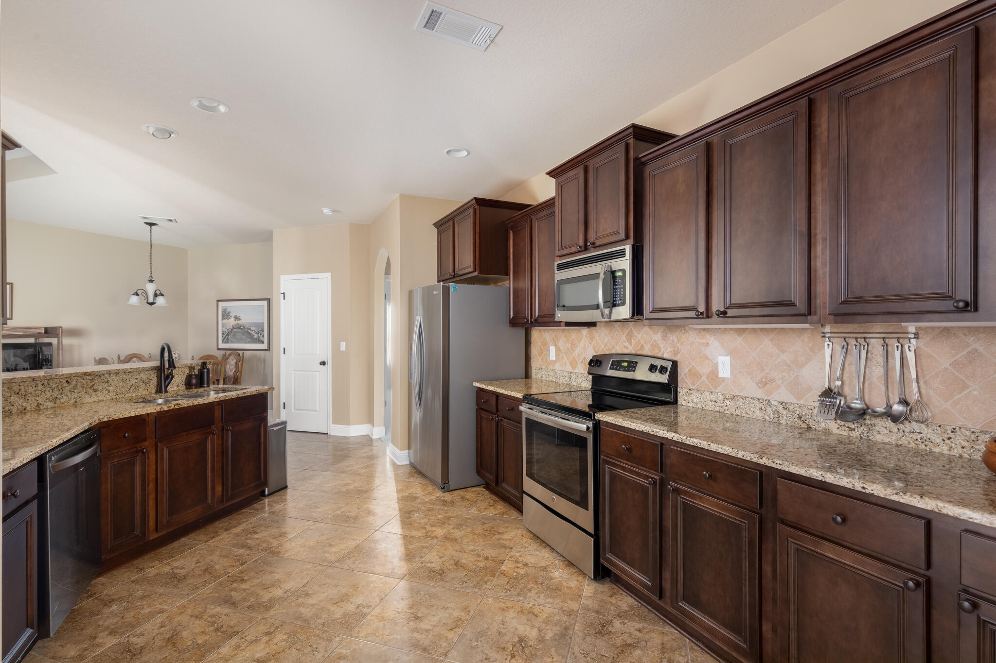 3379 Citrine Circle Crestview, FL 32539 - Photo 15 of 33 a large kitchen with stainless steel appliances and cabinets
