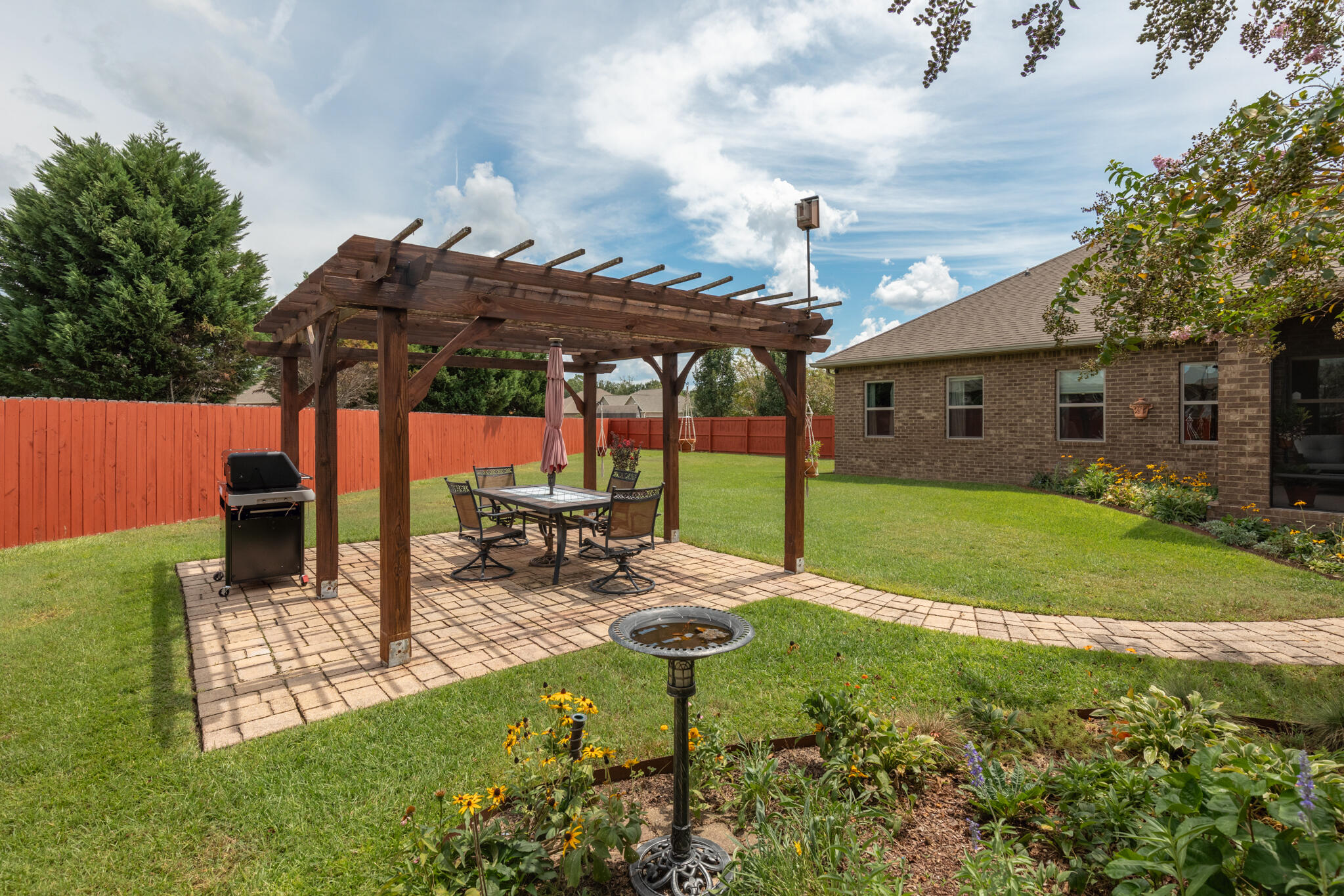 3379 Citrine Circle Crestview, FL 32539 - Photo 28 of 33 a view of a backyard with table and chairs under an umbrella