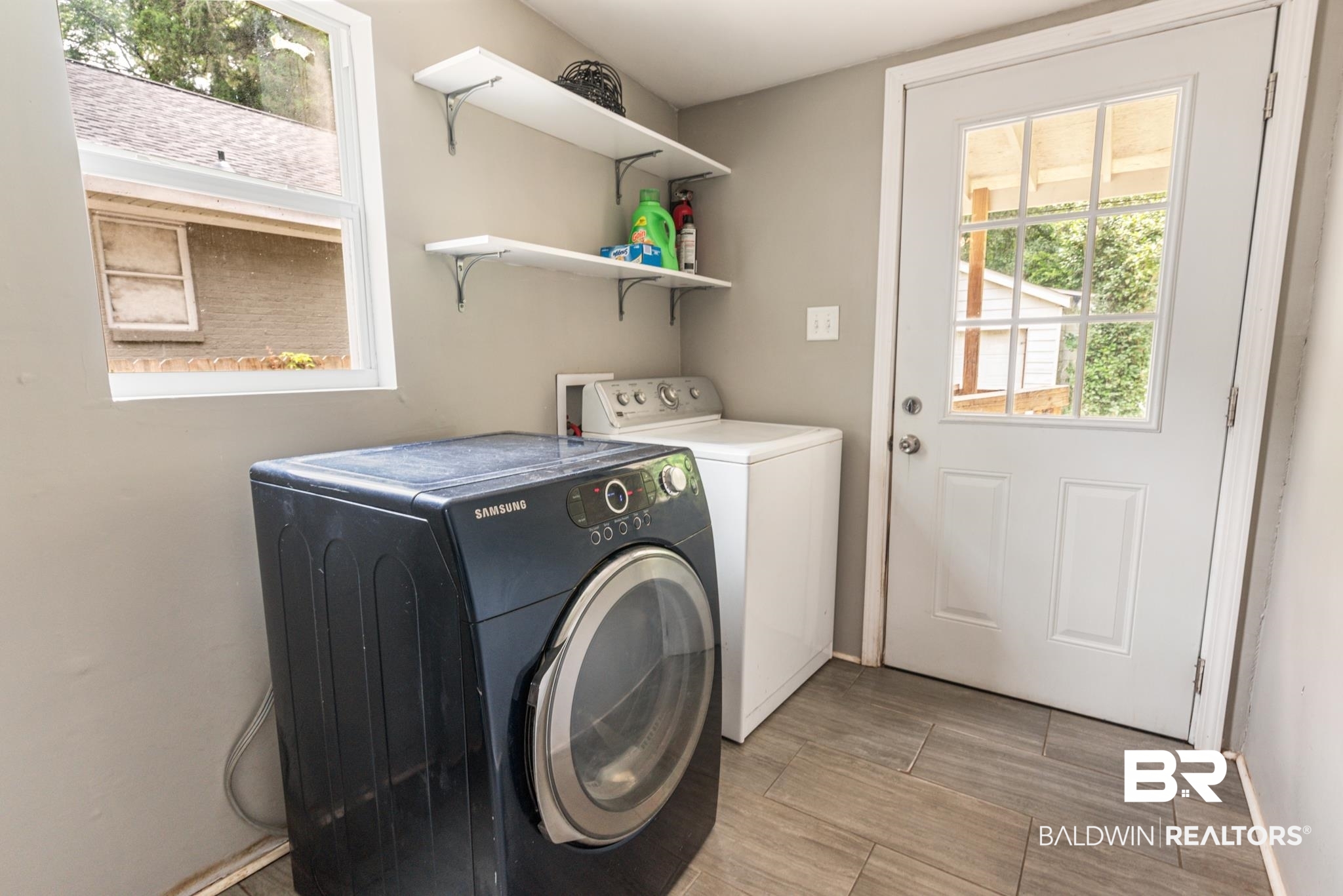 114 Crenshaw Street Mobile, AL 36606 - Photo 25 of 49 Clothes washing area featuring washing machine and dryer and light tile patterned floors
