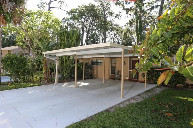 a view of a house with a yard and sitting area