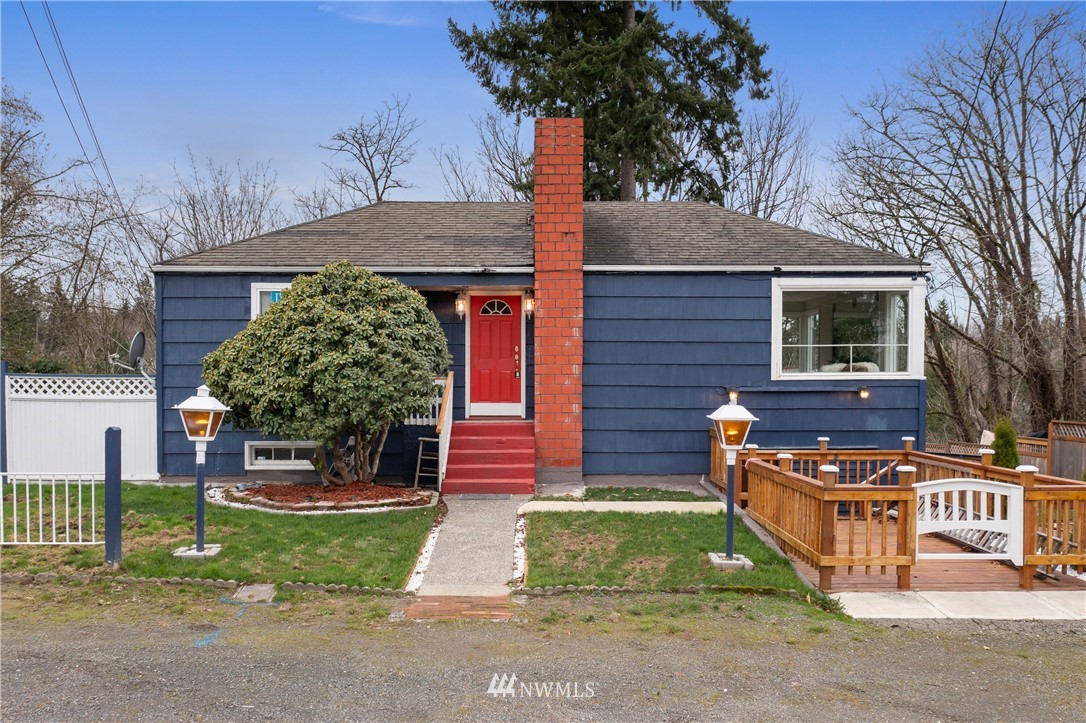 10651 Rustic Road South Seattle, WA 98178 - Photo 1 of 34 a front view of a house with garden