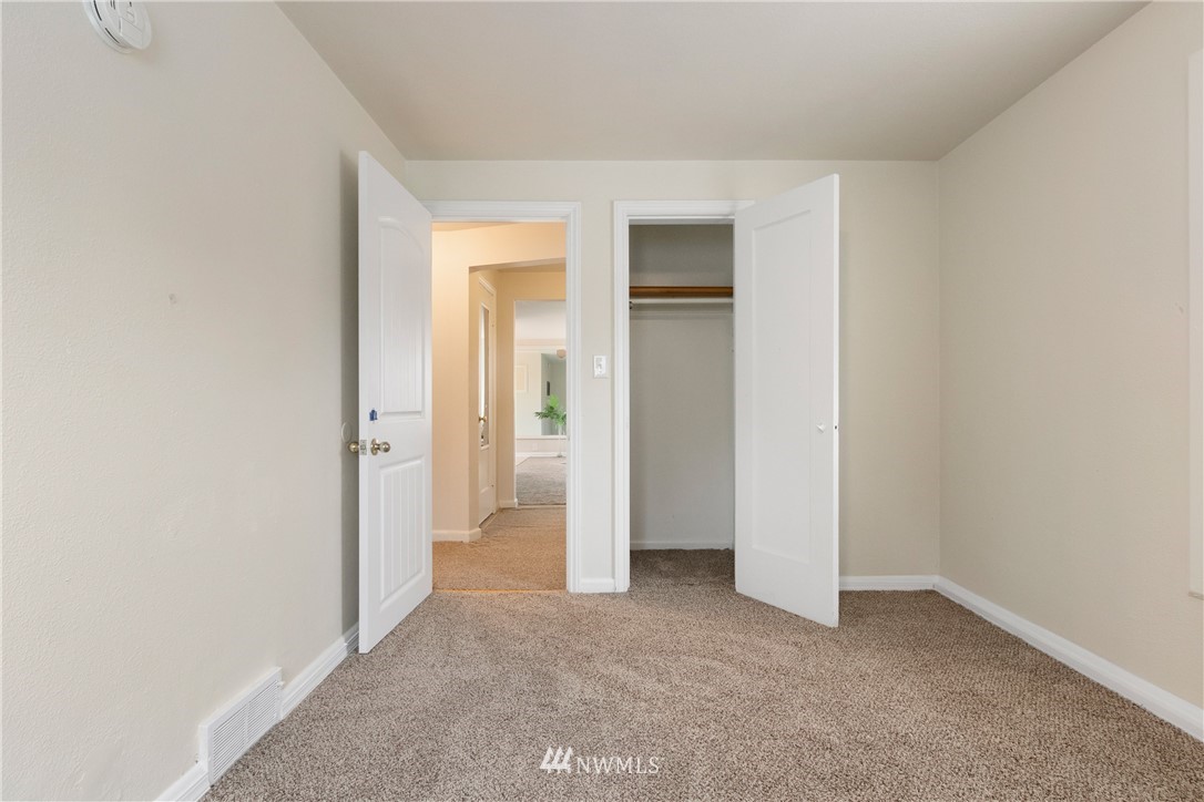 10651 Rustic Road South Seattle, WA 98178 - Photo 12 of 34 an empty room with closet and a bathroom