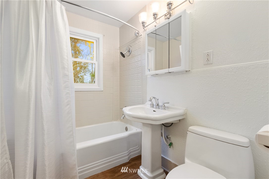10651 Rustic Road South Seattle, WA 98178 - Photo 15 of 34 a bathroom with a sink a toilet and shower