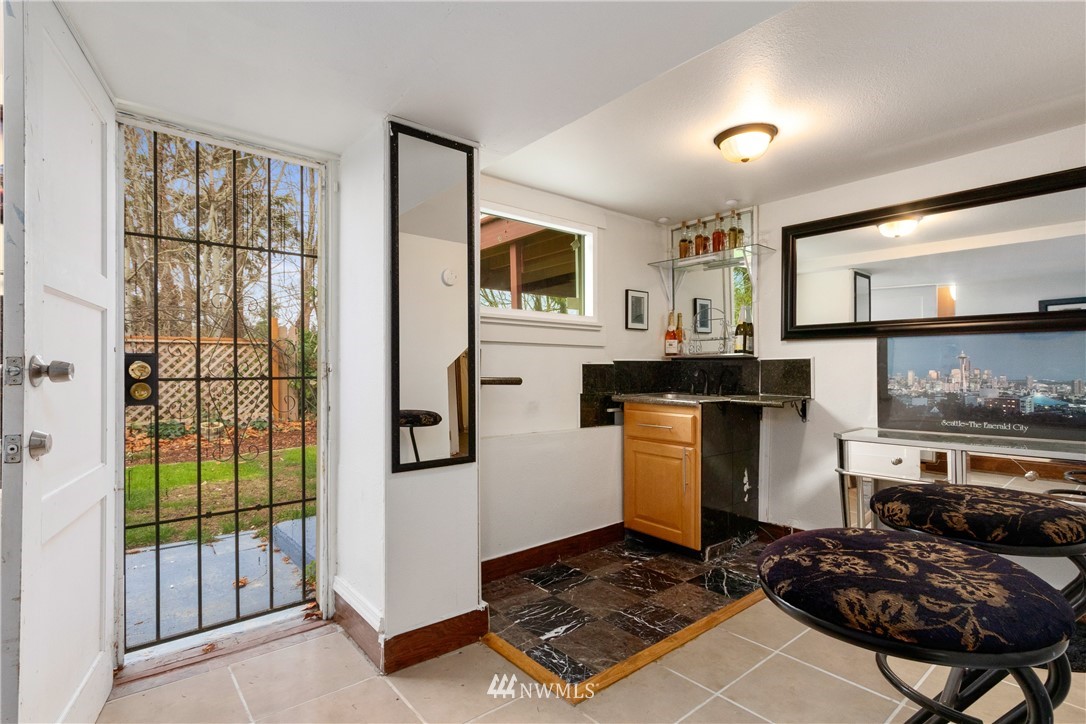 10651 Rustic Road South Seattle, WA 98178 - Photo 17 of 34 a living room with furniture and a floor to ceiling window