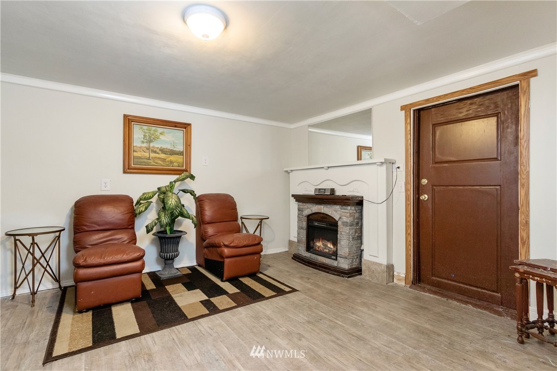 10651 Rustic Road South Seattle, WA 98178 - Photo 21 of 34 a living room with furniture a fireplace and next to a window