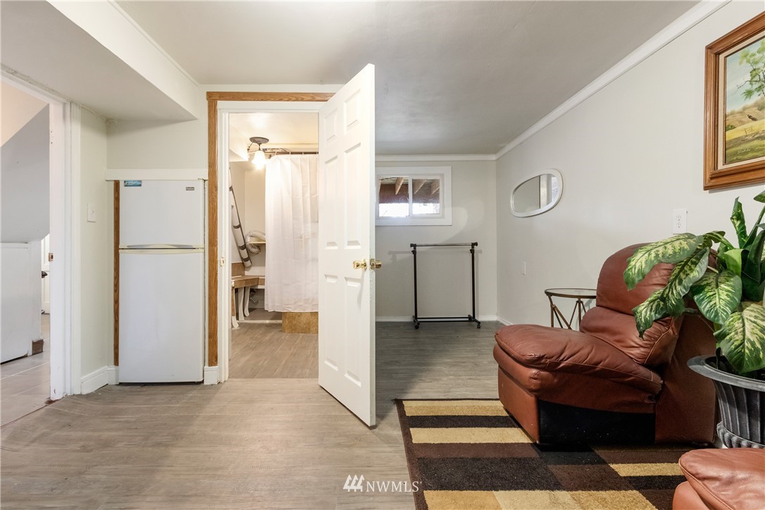 10651 Rustic Road South Seattle, WA 98178 - Photo 23 of 34 a living room with furniture and a refrigerator