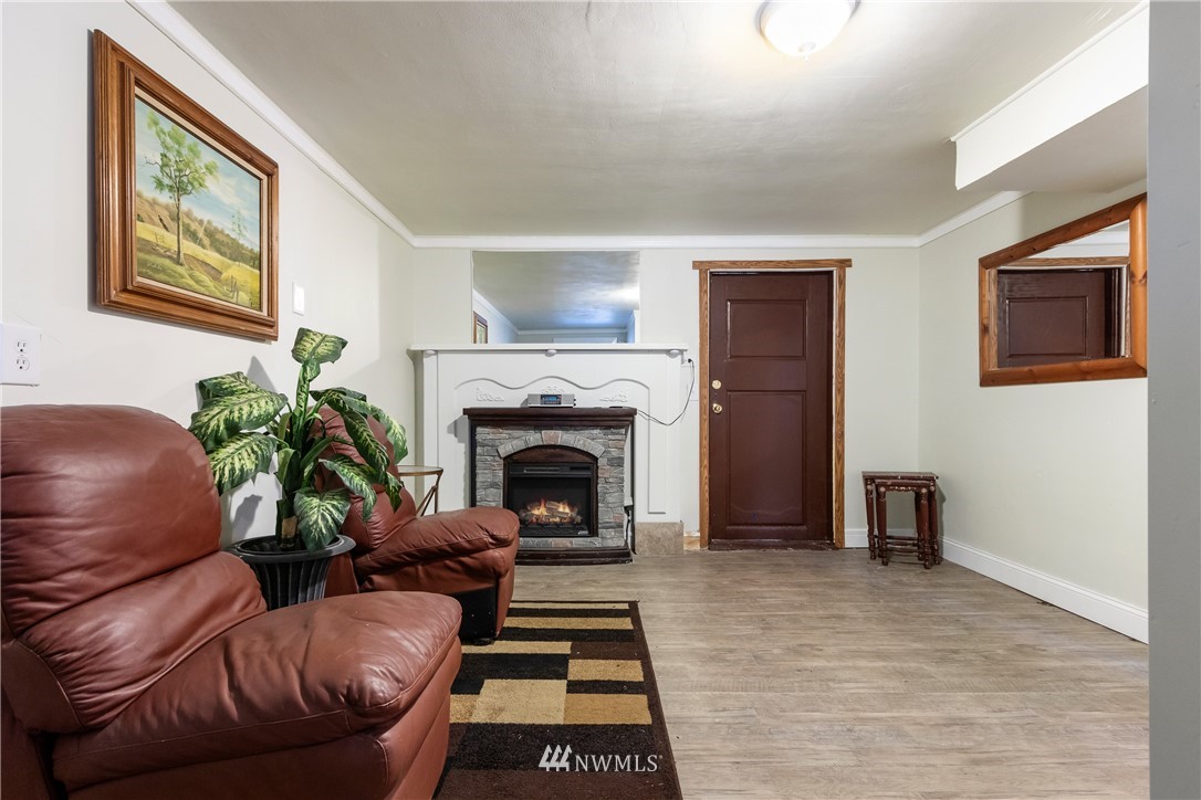 10651 Rustic Road South Seattle, WA 98178 - Photo 24 of 34 a living room with furniture and a fireplace