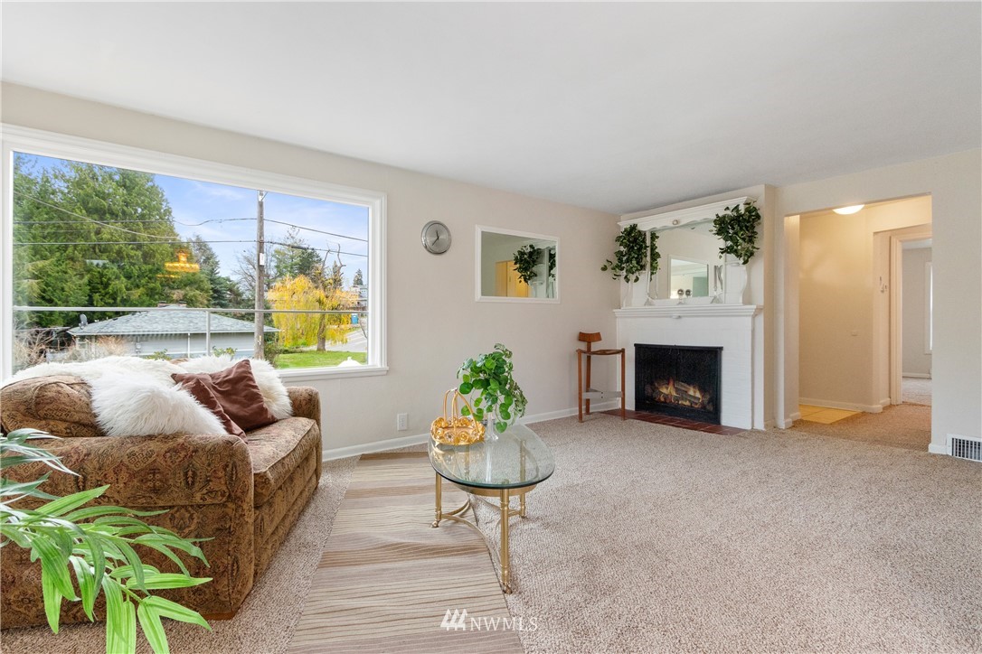 10651 Rustic Road South Seattle, WA 98178 - Photo 4 of 34 a living room with furniture and a fireplace