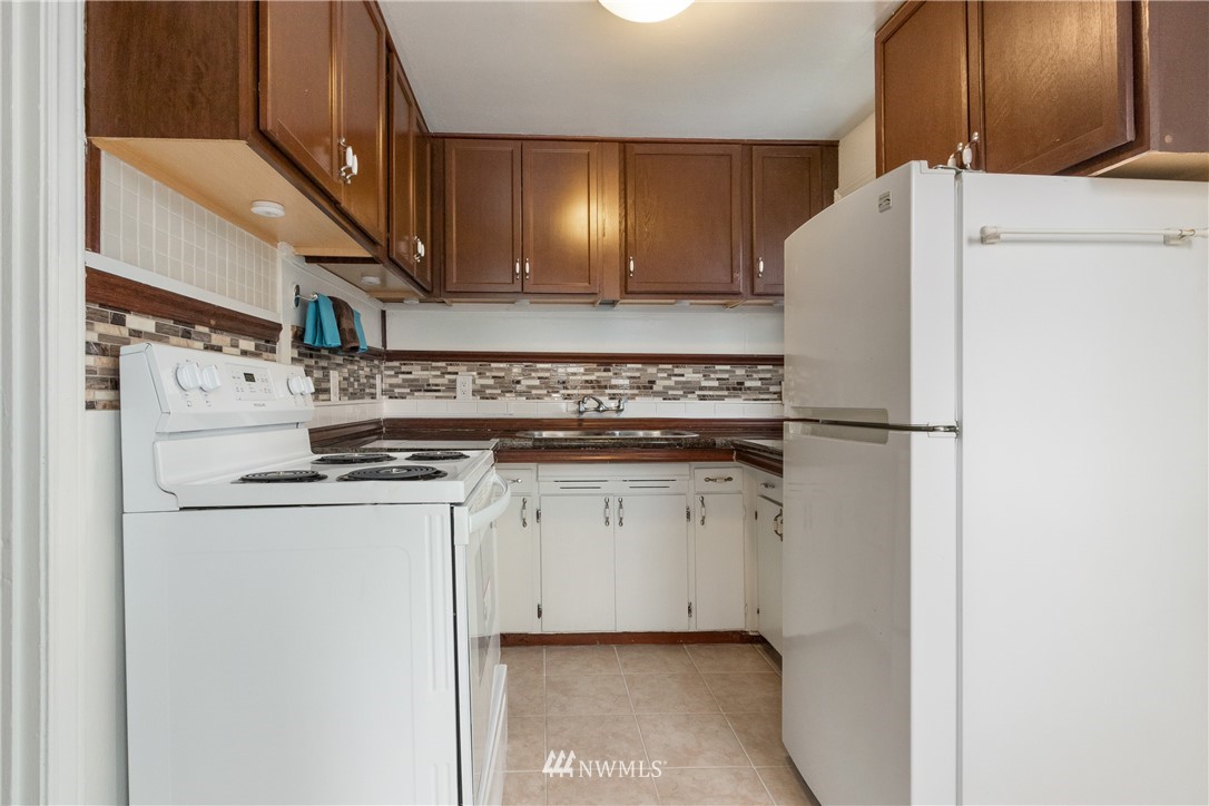 10651 Rustic Road South Seattle, WA 98178 - Photo 8 of 34 a kitchen with a refrigerator and a stove