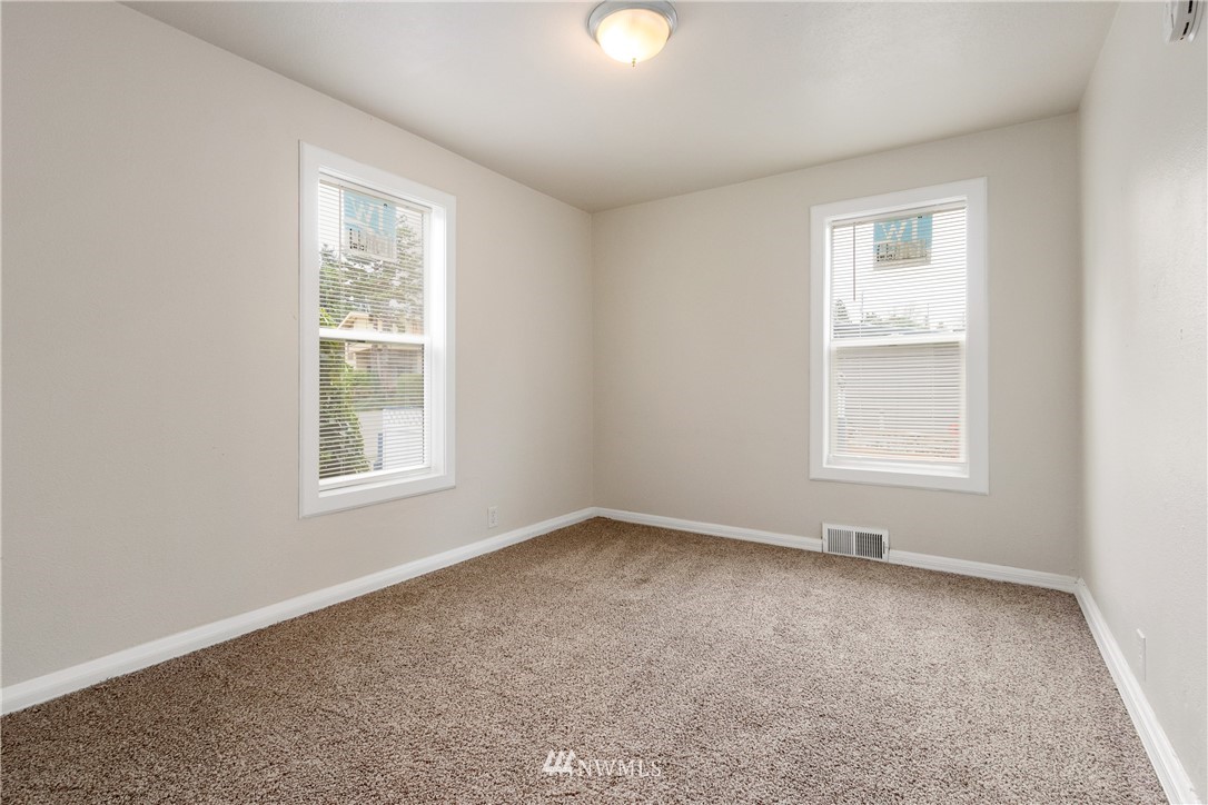 10651 Rustic Road South Seattle, WA 98178 - Photo 10 of 34 an empty room with windows