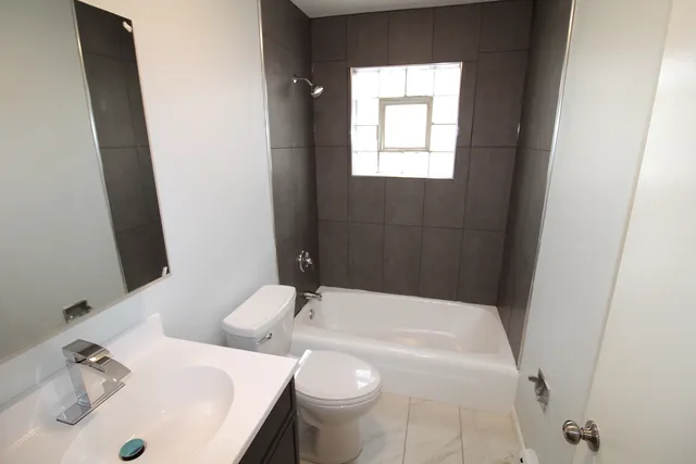 a bathroom with a sink toilet and mirror