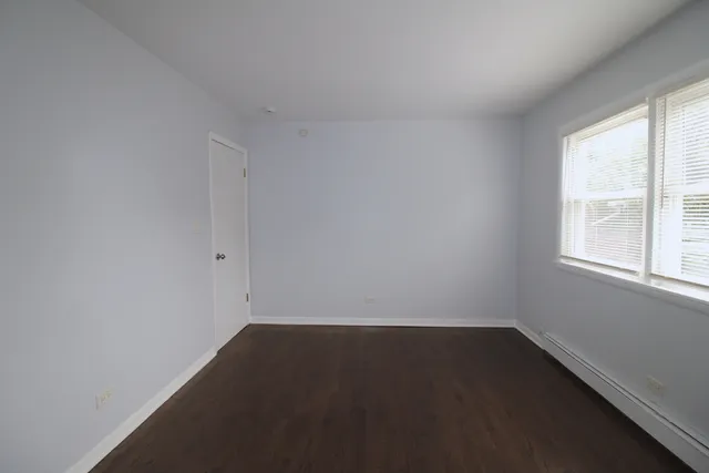 a white house that has a tree in front of it