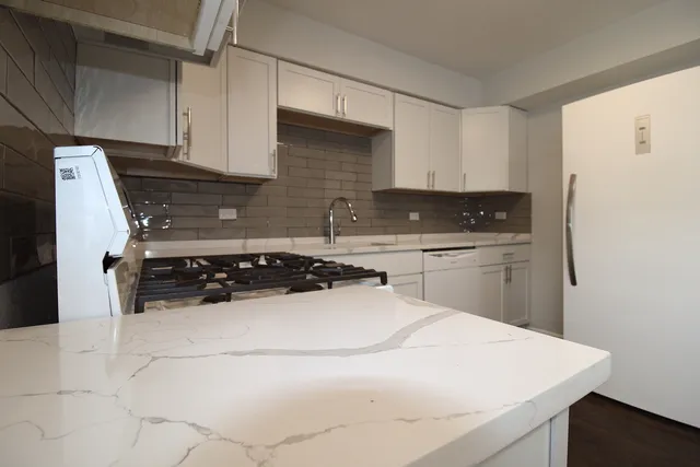a kitchen with a sink a stove and refrigerator