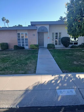 a front view of house with yard and green space