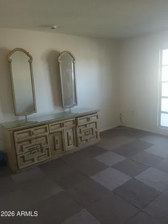 a bathroom with a granite countertop sink a mirror and vanity