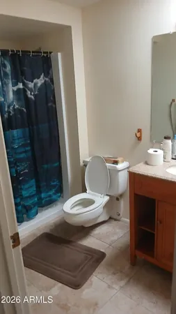 a white toilet sitting next to a bathroom sink