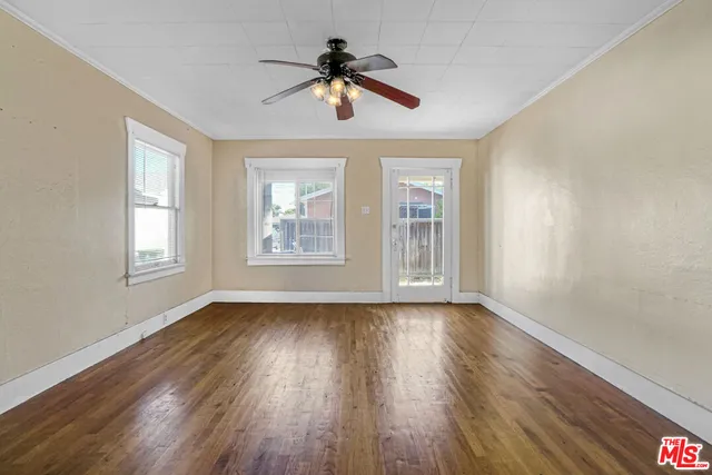 a view of room with window ceiling fan and hardwood floor