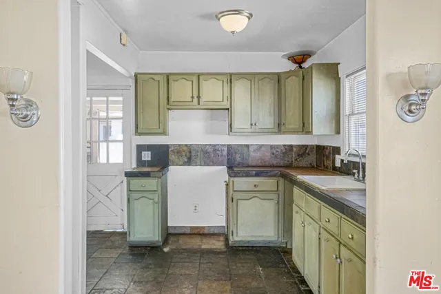 a kitchen with a sink and cabinets